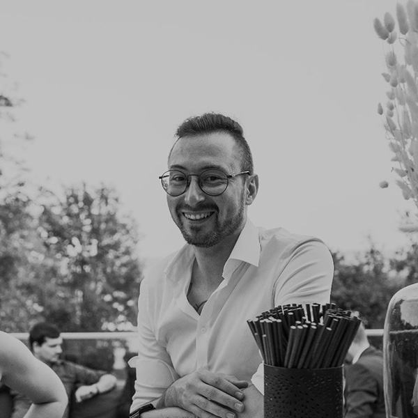 a man sitting at a table with a drink