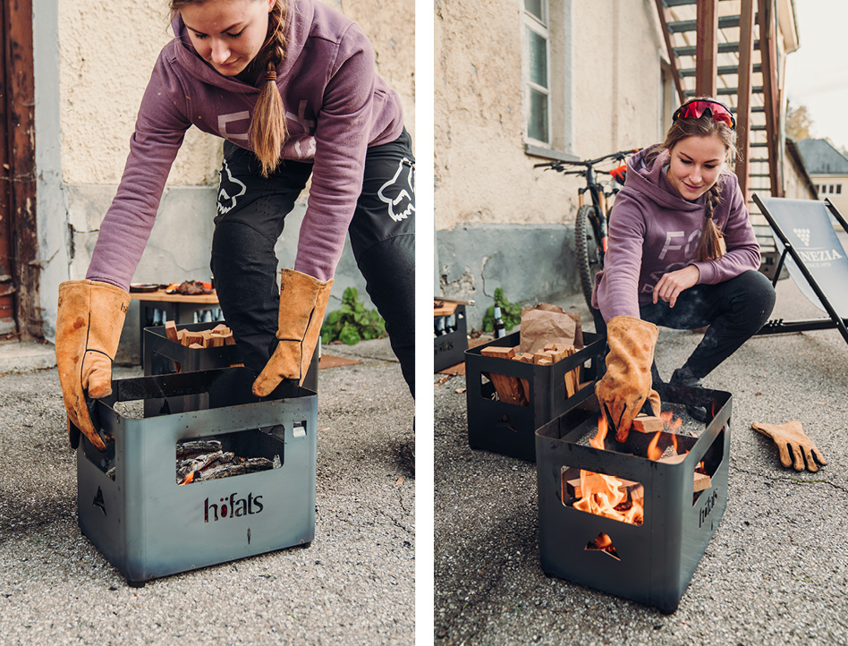 Illustrated is a woman is putting a fire in a box, with the BEER BOX Fire Basket.