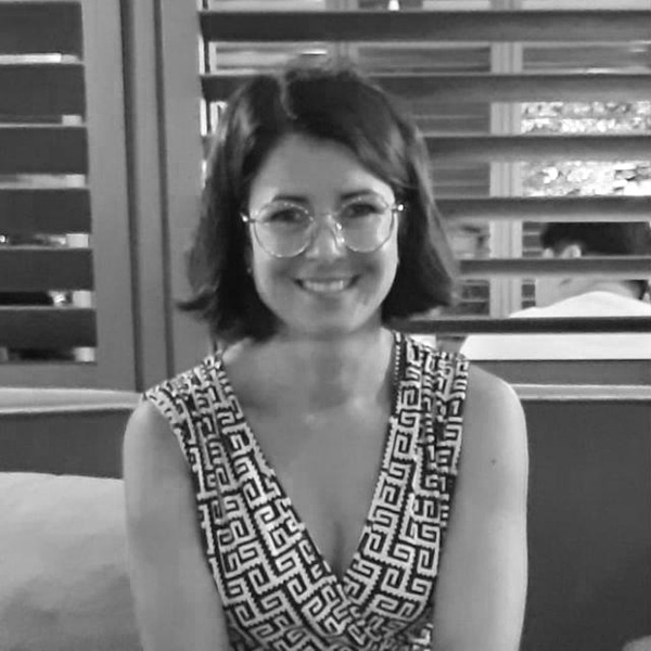 a woman sitting on a couch in front of a window