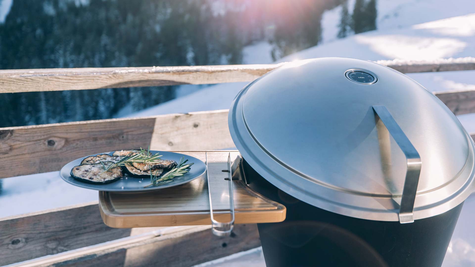 La photo présente une assiette de nourriture sur un grill sur une terrasse, avec le CONE Tablette.
