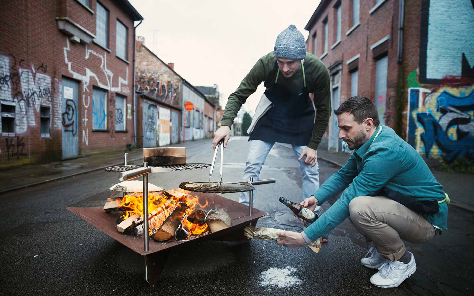 An image showing two men roasting marsh on a fire, with the BBQ Starter.