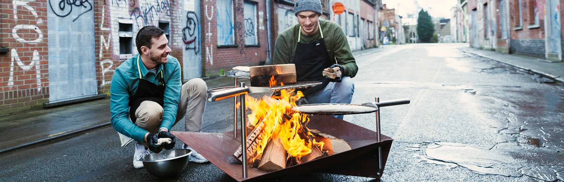 Illustrated is two people sitting around a fire pit, with the BBQ Starter.