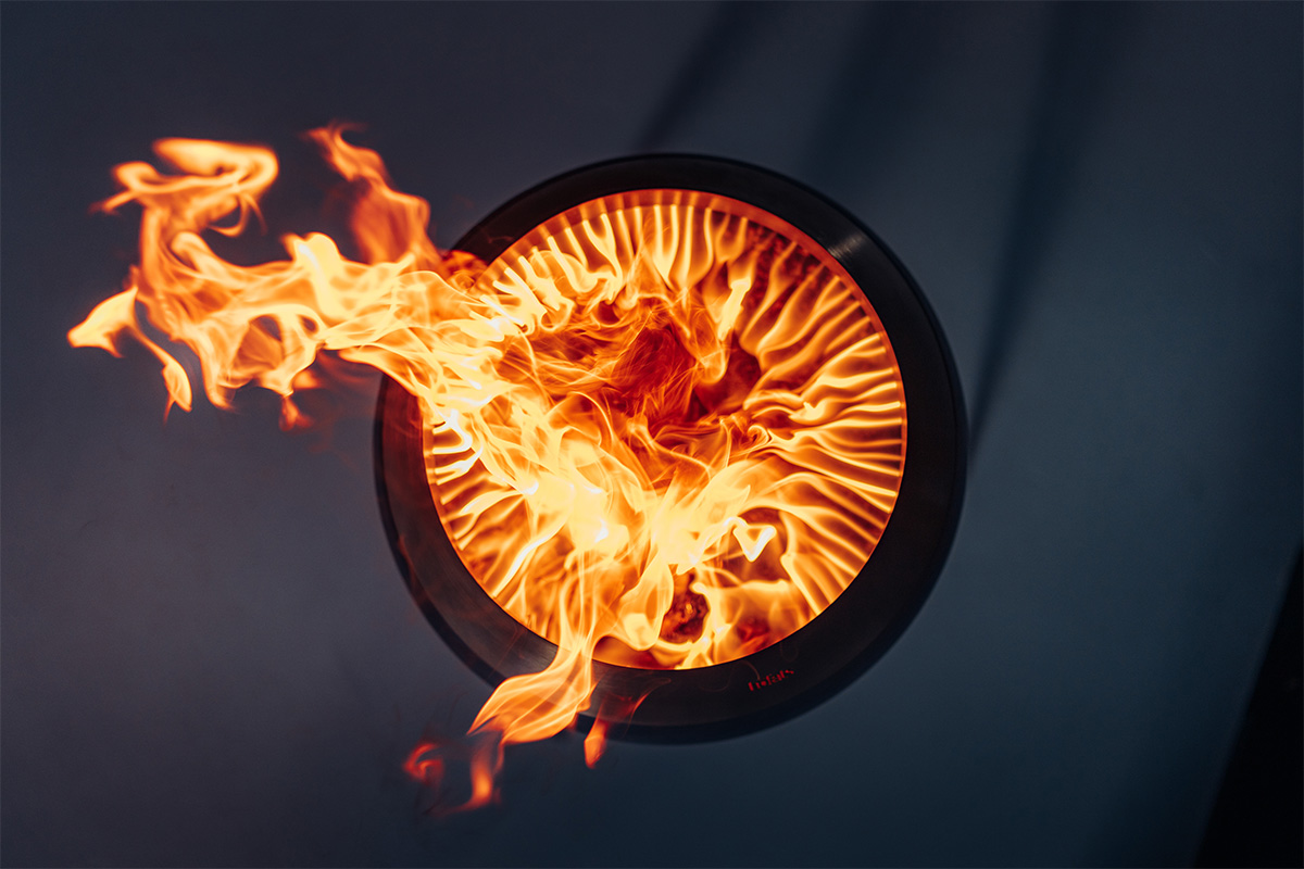 MOON 45 Set de feu flex Une scène accueillante avec un feu brûlant dans un bol noir, mis en valeur par la présence du 00717 MOON 45 avec un support haut.