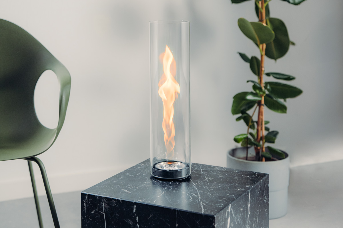 SPIN air 1200 Built-in A black marble table with a glass cylinder on top, with the 00975 Spin Air 1200 built-in adding a functional and elegant touch to the scene.