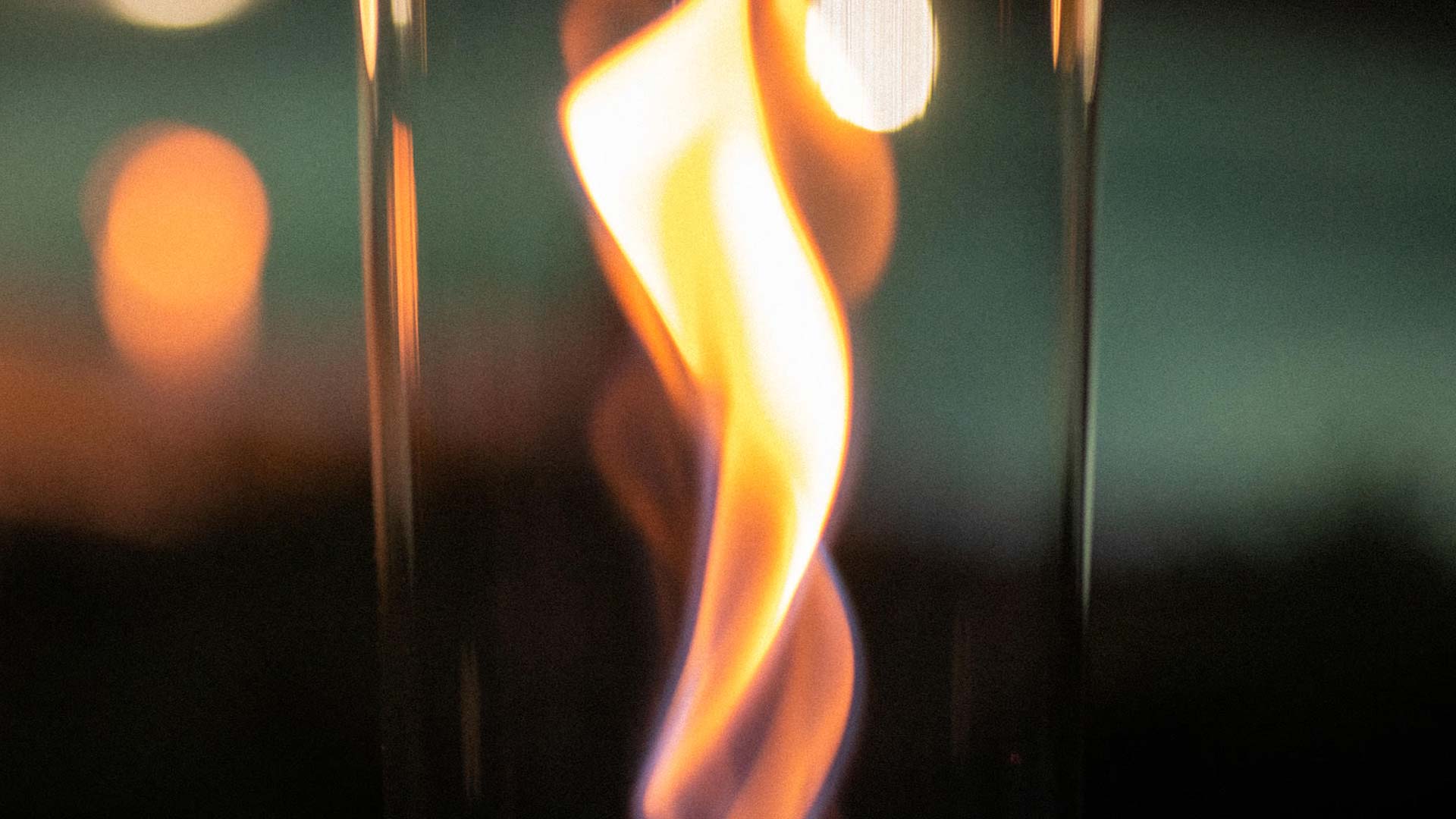 A depiction of a close up of a glass with a fire in it, featuring the Spin Bioethanol as a central and purposeful element.