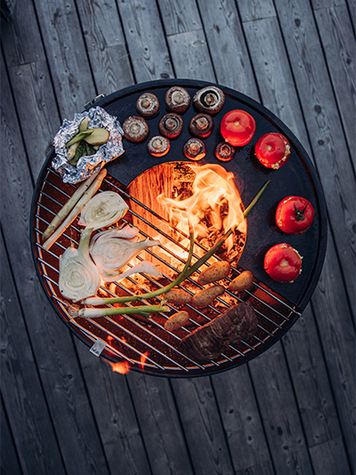 The photo presents a grill with food on it, with the BOWL Grid.