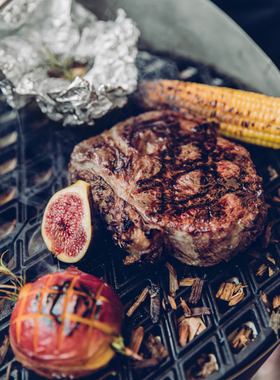The 010301 CONE Cast Iron Grid is shown as a steak on a grill with a side of fruit, creating a stylish and accessible visual.