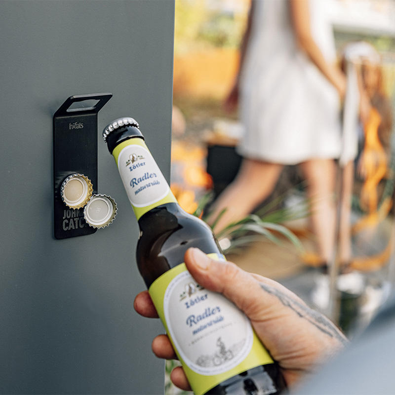 Un décapsuleur est fixé à un mur, enrichi par la présence du Johnny Catch Aimant, qui allie design et utilité.