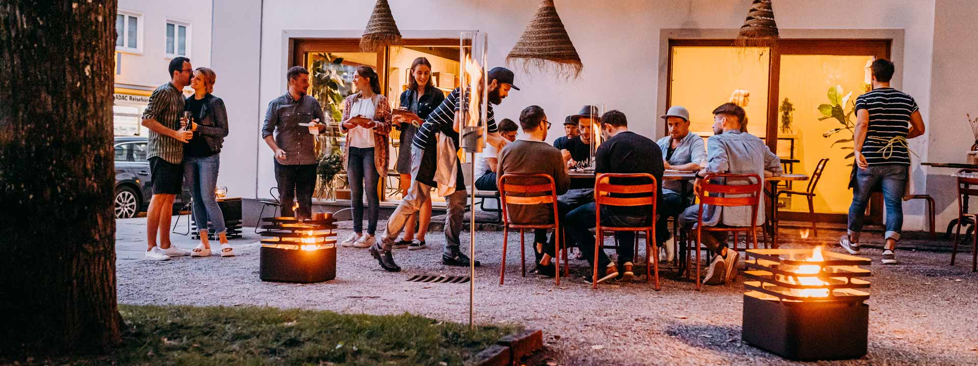 An image showing people sitting around a fire pit in a backyard, with the discount total value of.