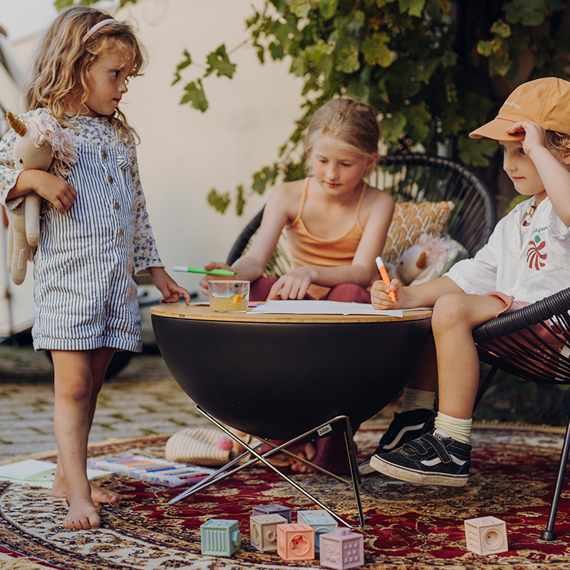 An inviting scene with a group of children sitting on a rug, highlighted by the presence of the Bowl 57 with starstand