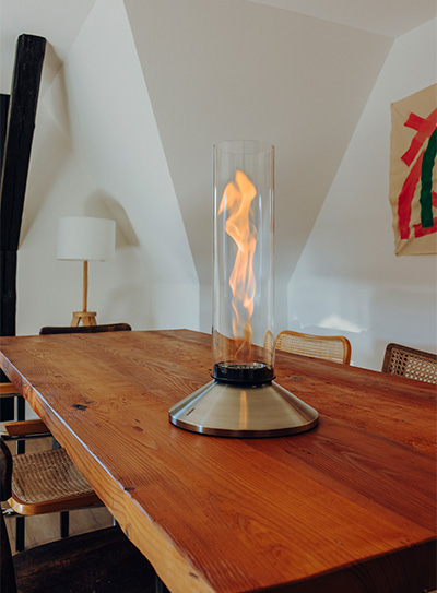 SPIN X Tischfeuer in silber auf einem Holztisch