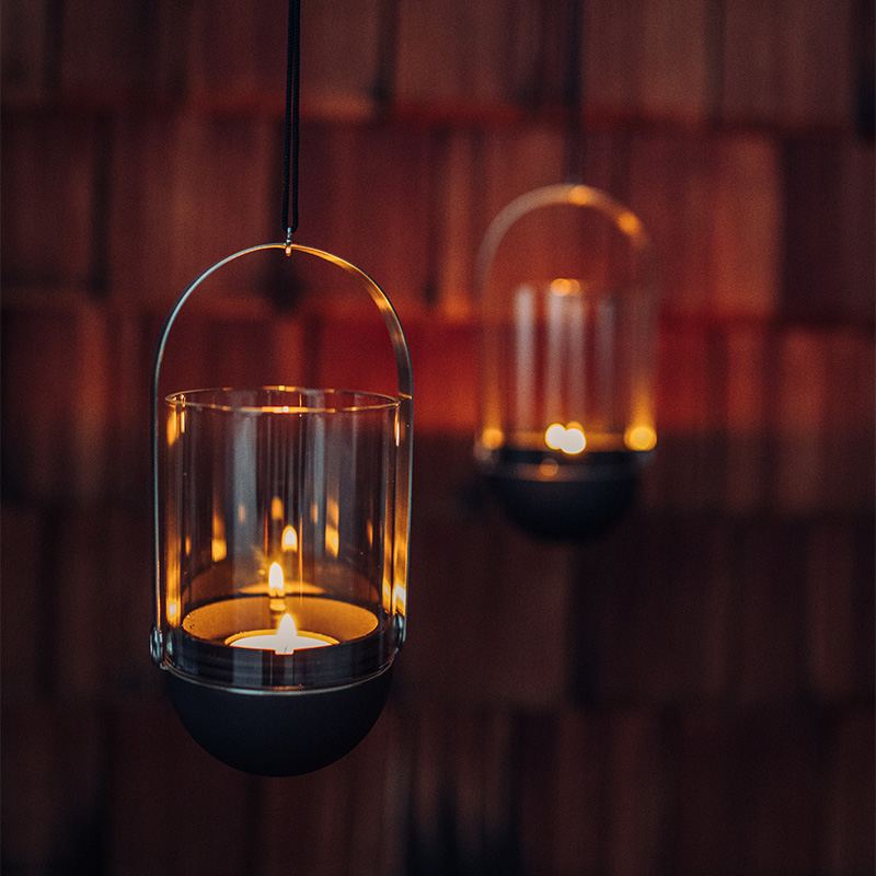a couple of hanging lights in a room with the refined touch of the Gravity Candle