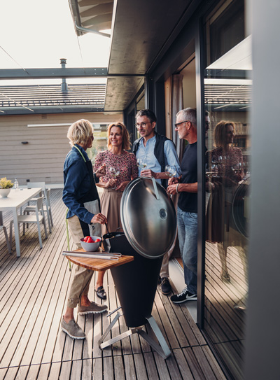 An image showing a group of people standing around a bb on a deck, with the CONE Board.
