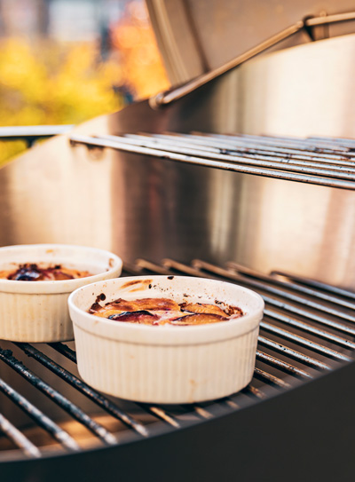 This image shows two small bowls of food on a grill, with the CONE Charcoal Grill.