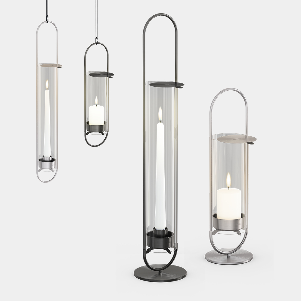 Quatre lanternes en verre avec une bougie et un bougeoir, montrant la OVAL CANDLE.