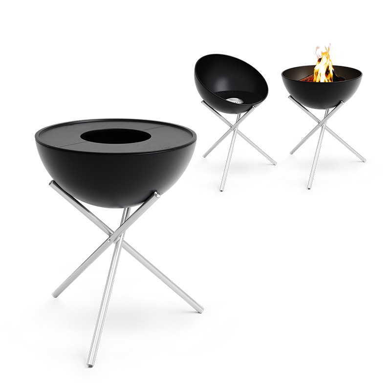 Two black fire bowls with a fire in the middle, enriched by the presence of the 00487 BOWL Pancha BBQ Set high, which merges design with utility.