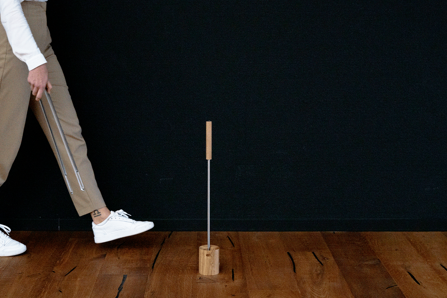 Fire Tools Set 3 pcs a man is standing on a wooden floor with a stick.