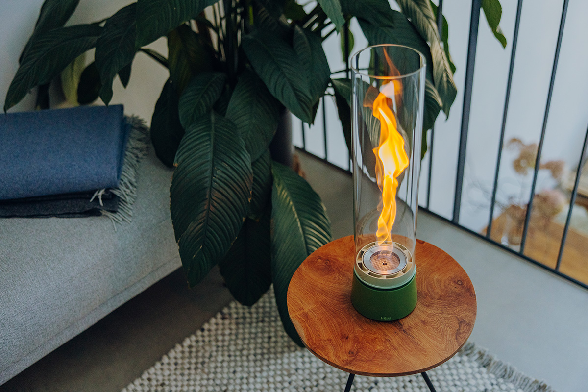 SPIN air 1200 Tabletop Fireplace enamel green Scene showing a small table with a SPIN on it, where the 00819 Spin Air 1200 Tablefire Emaille green stands out for its practical elegance.